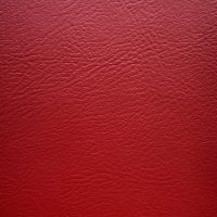 Close-up of a textured red vinyl surface.