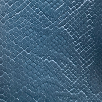 Close-up of a blue textured surface with a pattern resembling reptile scales